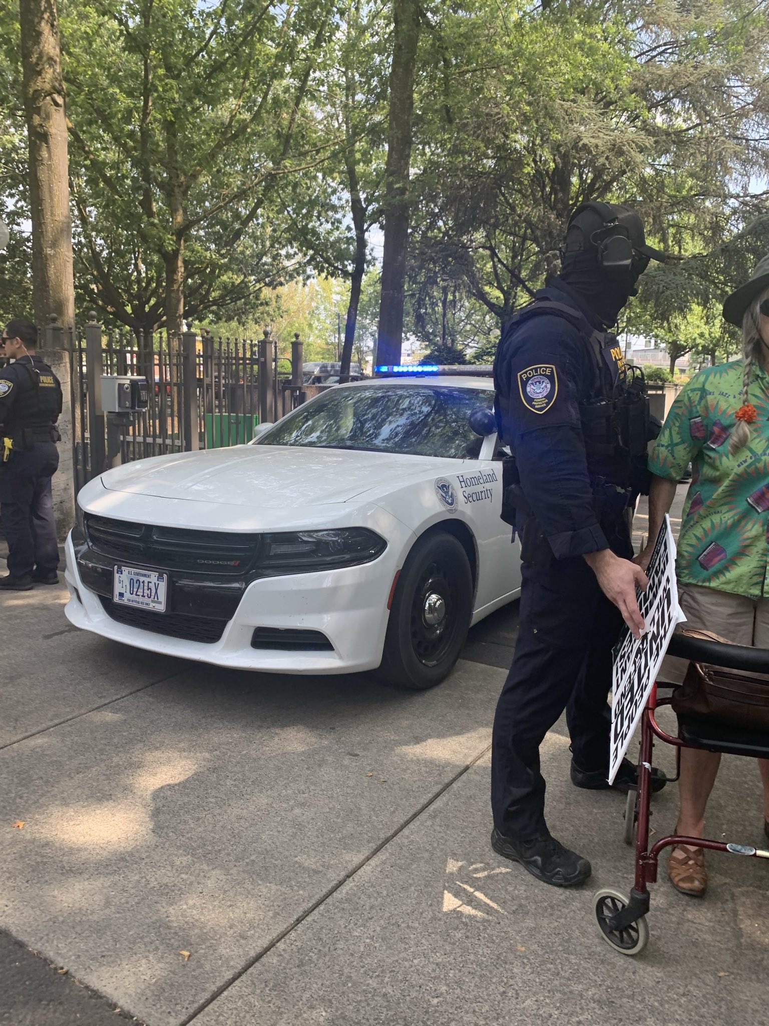 DHS agent intimidating elderly person with a walker at Eugene Federal building